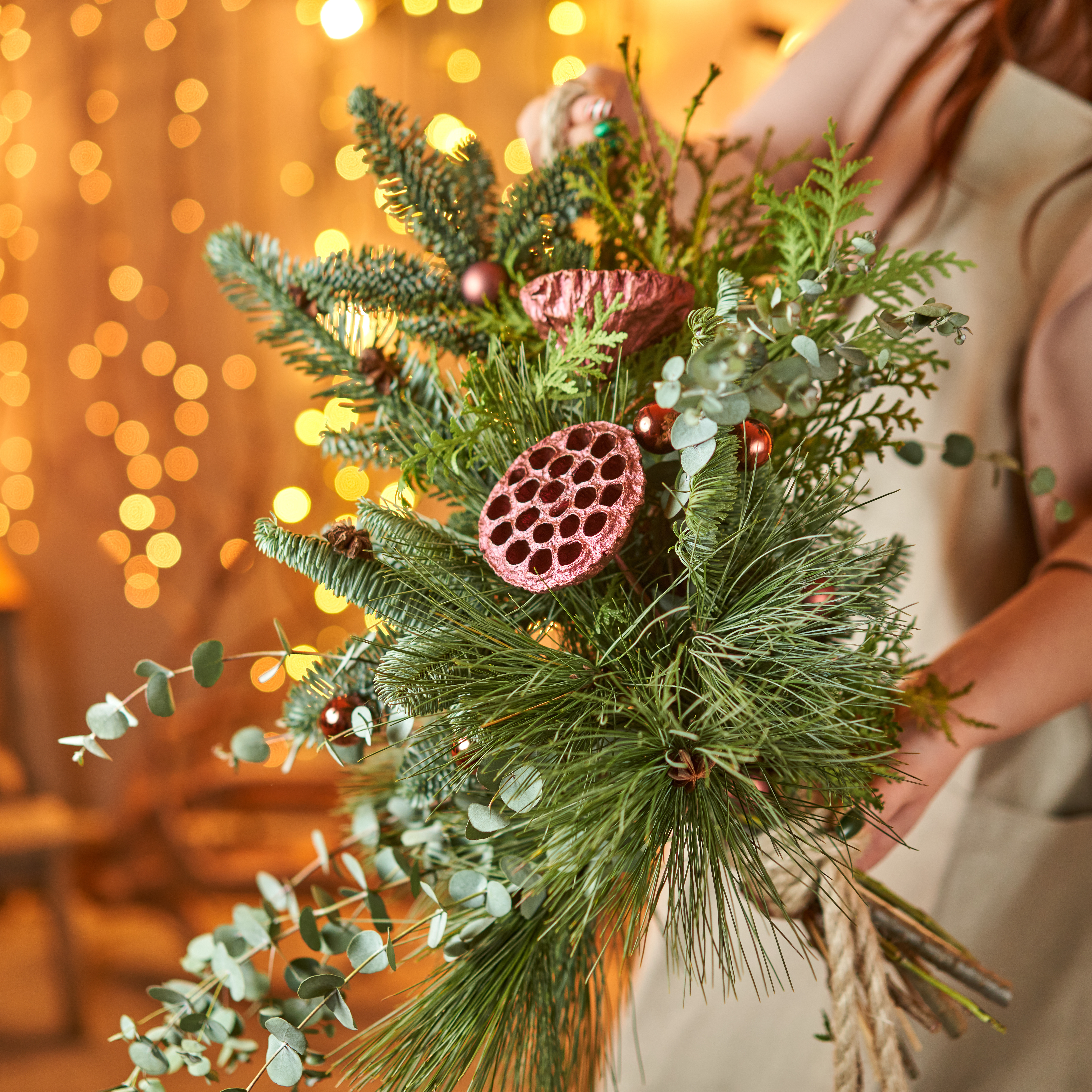 Hand-tied Christmas bouquet of fresh evergreen foliage and eucalyptus, a thoughtful festive gift idea for gardeners